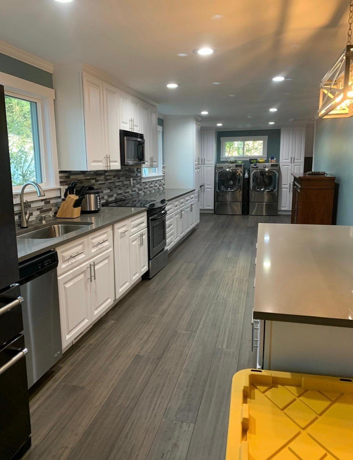 Long kitchen with gray plank floors